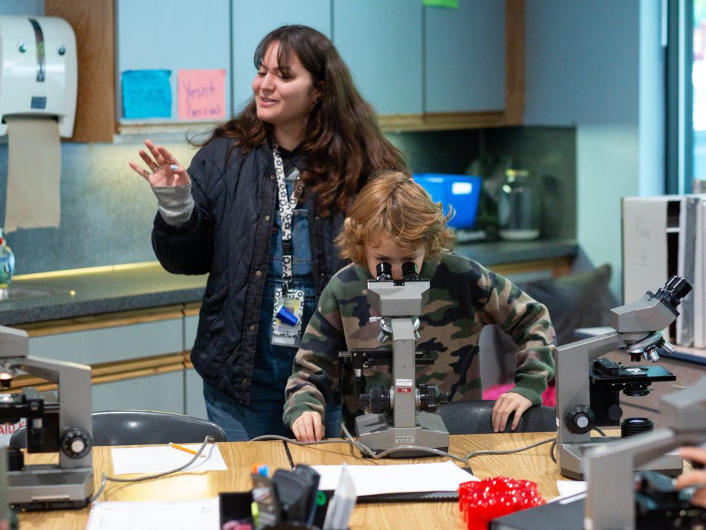 Student and teacher in science class